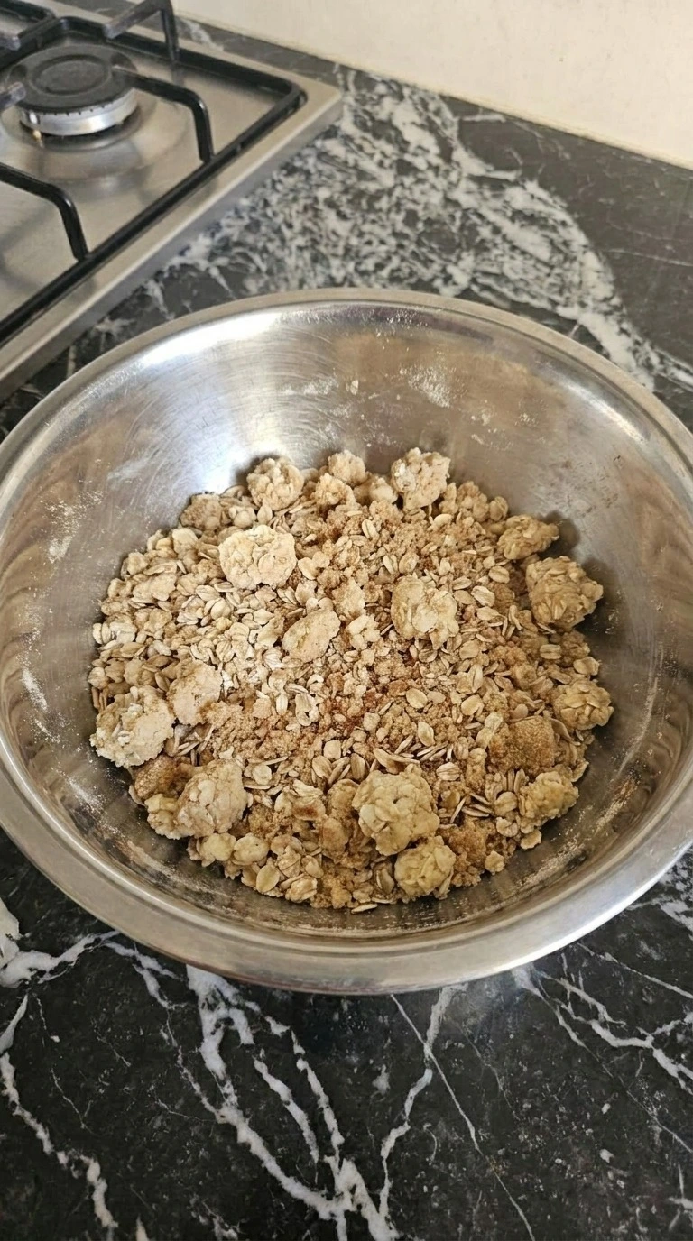 Apple Crisp with Oatmeal Crumble step 2: pinch the cold oatmeal crumble with visible texture changes Recipe focus: apple crisp with canned apple filling.