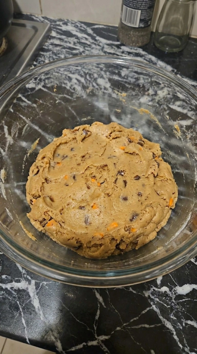 Mixed dough for Brown Butter Halloween Candy Cookies with visible toasted brown butter flecks