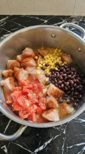 Chicken Taco Soup ingredients combined in pot with chicken beans and broth Recipe focus: taco soup recipe.