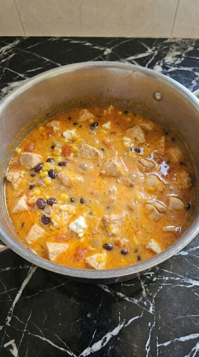 Chicken Taco Soup creamy broth with melted cheese and chicken pieces Recipe focus: taco soup crock pot.