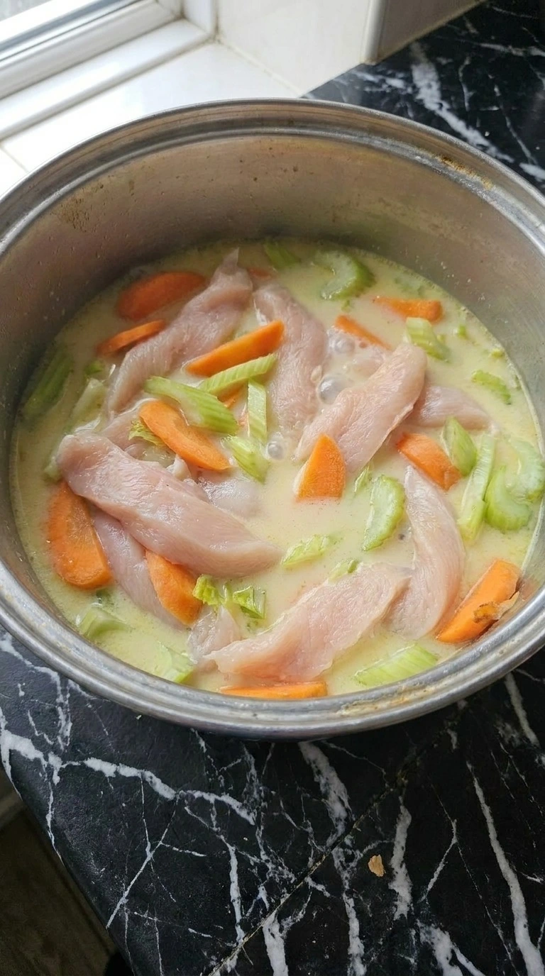 Creamy Chicken Noodle Soup simmering chicken vegetables and broth Recipe focus: chicken noodle soup homemade.