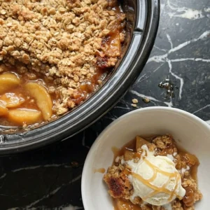 Crockpot Apple Crisp with Pie Filling with golden oat crumble and warm apple slices topped with vanilla Recipe focus: crock pot apple crisp with pie filling.