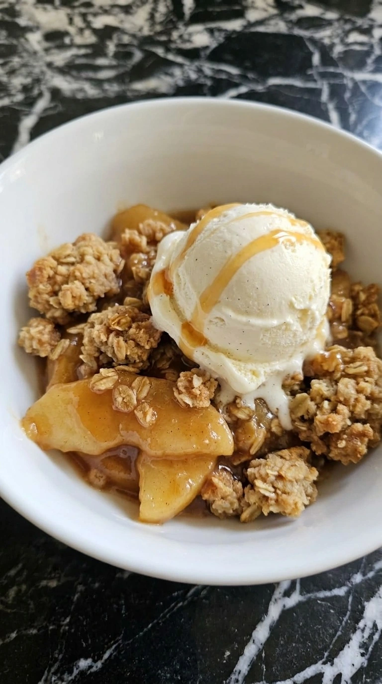 Crockpot Apple Crisp with Pie Filling served warm with golden crumble and melting vanilla bean ice cream Recipe focus: crock pot apple crisp with pie filling.
