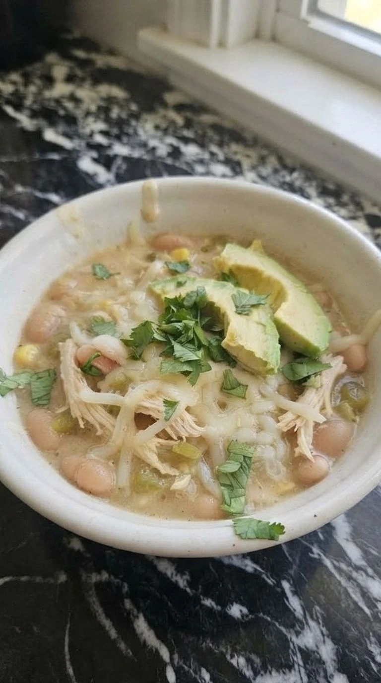 Crockpot White Chicken Chili in a bowl with tender chicken and creamy beans Recipe focus: chicken chili recipe.