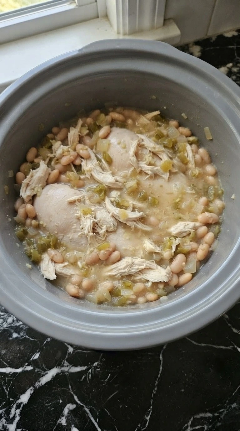 Crockpot White Chicken Chili with tender shredded chicken after slow cooking Recipe focus: chicken chili recipe.
