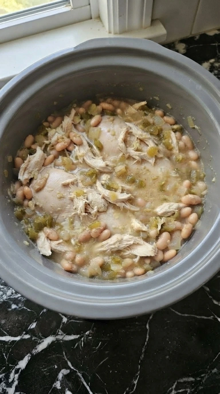 Crockpot White Chicken Chili with creamy broth and shredded chicken texture Recipe focus: chicken chili recipe.