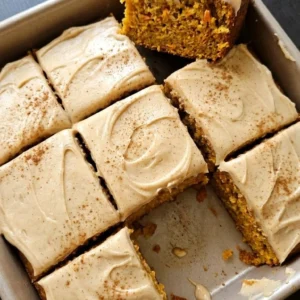 Fall Desserts for People Who Hate Pumpkin shown as apple carrot spice cake squares with brown butter cream cheese frosting