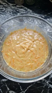 Grating apple and carrots into the wet mixture for Fall Desserts for People Who Hate Pumpkin