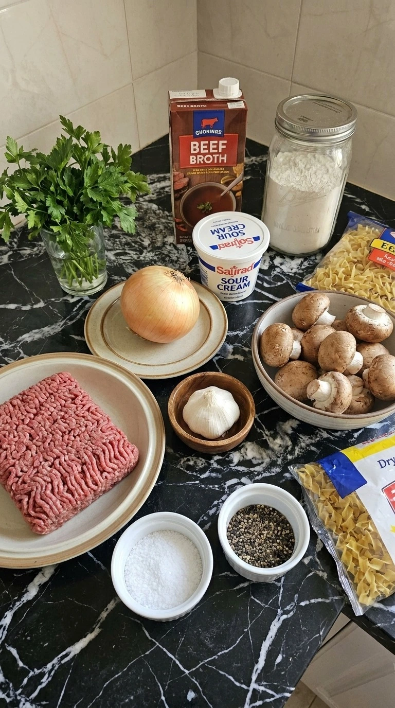 Ground Beef Stroganoff ingredients with beef mushrooms noodles and sauce components Recipe focus: beef stroganoff with ground beef.