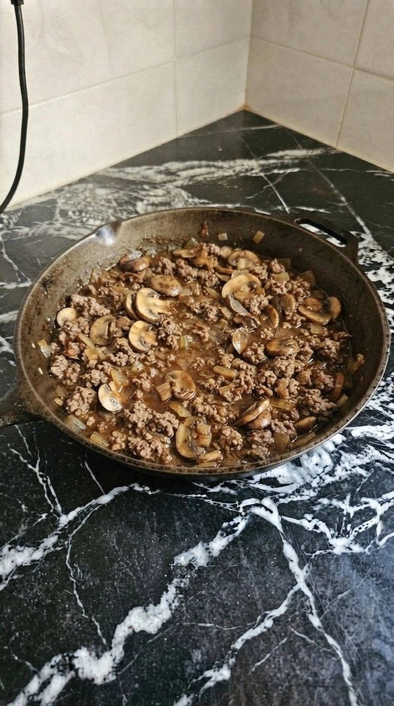 Ground Beef Stroganoff sauce thickening with mushrooms and browned beef Recipe focus: beef stroganoff recipe.
