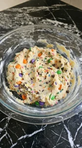 Halloween Cake Mix Cookies dough mixed thick with colorful candy pieces and mini chocolate chips Recipe focus: cake mix halloween cookies.