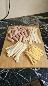 Halloween Cocktail Party Appetizers step with puff pastry strips, chicken sausages and cheddar batons
