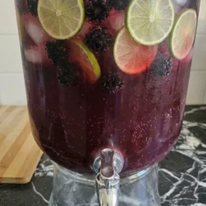 Halloween Cocktails for a Crowd with dark berry punch, lime wheels, blackberries and ginger beer bubbles Recipe focus: easy halloween cocktails for a crowd.