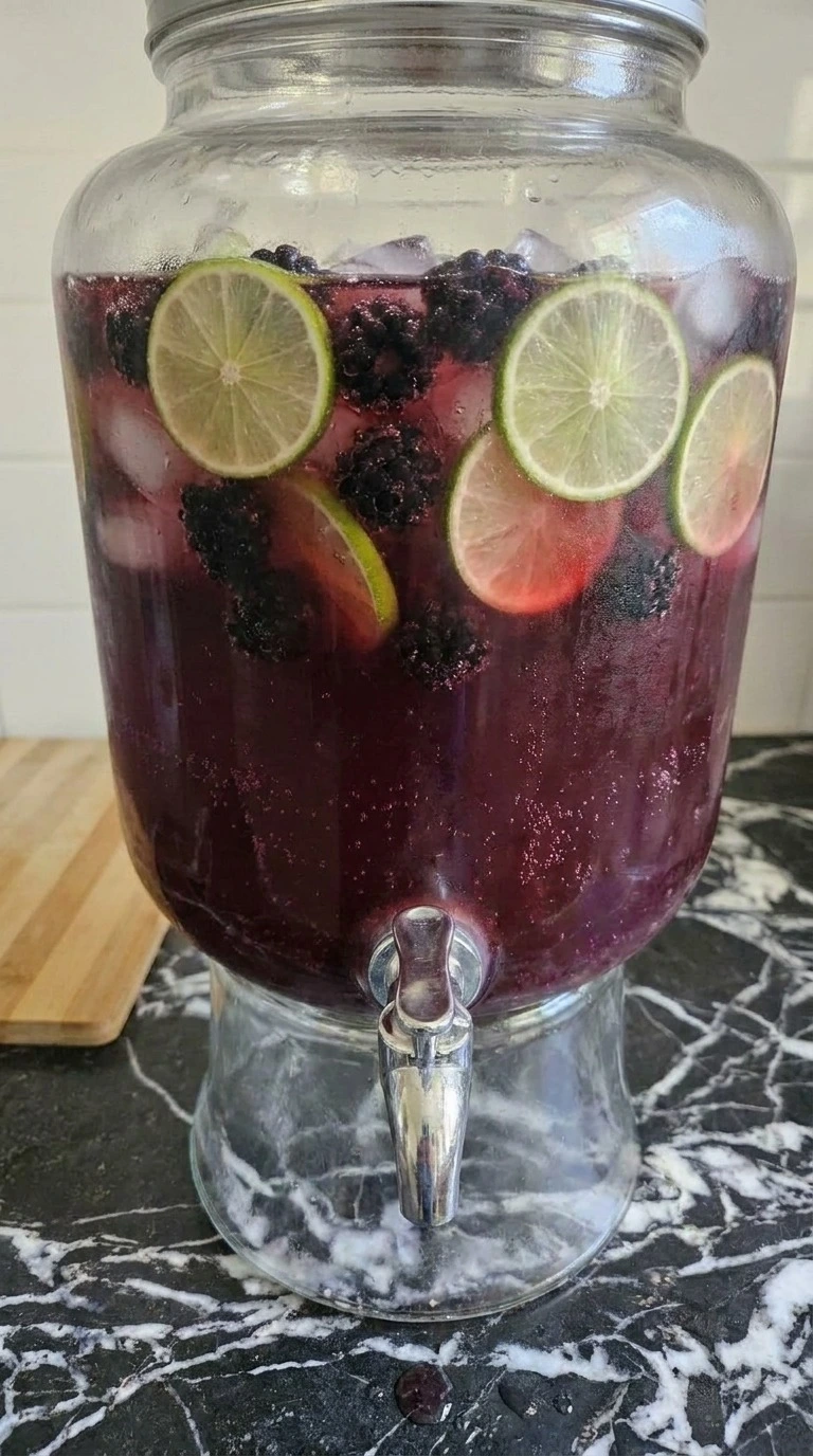 Halloween Cocktails for a Crowd with dark berry punch, lime wheels, blackberries and ginger beer bubbles Recipe focus: easy halloween cocktails for a crowd.