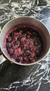Halloween Cocktails step with deep purple blackberry syrup simmering around partially collapsed fresh Recipe focus: easy halloween cocktails recipes.