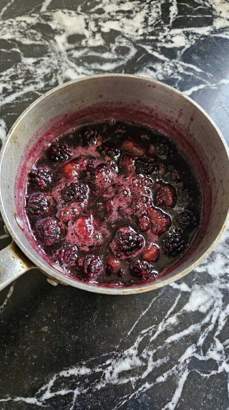 Halloween Cocktails step with deep purple blackberry syrup simmering around partially collapsed fresh Recipe focus: easy halloween cocktails recipes.