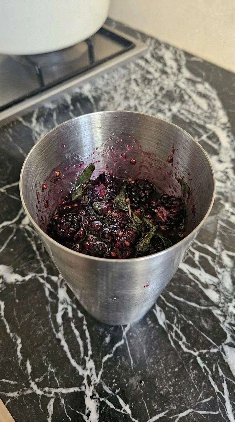 Muddling blackberries and sage for Halloween Cocktails Vodka Recipe focus: halloween cocktails easy vodka.