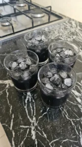 Straining Halloween Cocktails Vodka over irregular crushed ice in rocks glasses Recipe focus: halloween cocktails easy vodka.