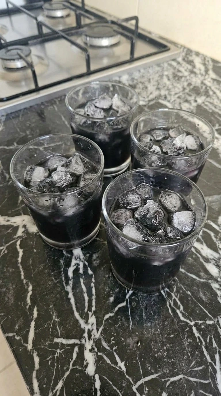 Straining Halloween Cocktails Vodka over irregular crushed ice in rocks glasses Recipe focus: halloween cocktails easy vodka.