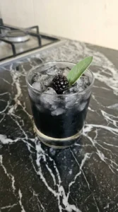 Finished Halloween Cocktails Vodka garnished with fresh blackberry and sage Recipe focus: halloween cocktails easy vodka.