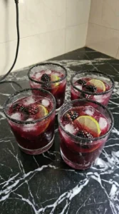 Halloween Drinks Alcohol Cocktails finished in rocks glasses with blackberries, lime and black sugar rims Recipe focus: halloween drinks alcohol cocktails easy.