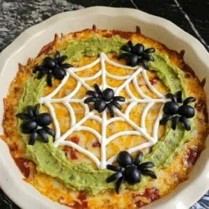 Halloween Food for Party Appetizers Dip with melted cheddar, guacamole spiderweb topping and Recipe focus: halloween food for party appetizers dip recipes.