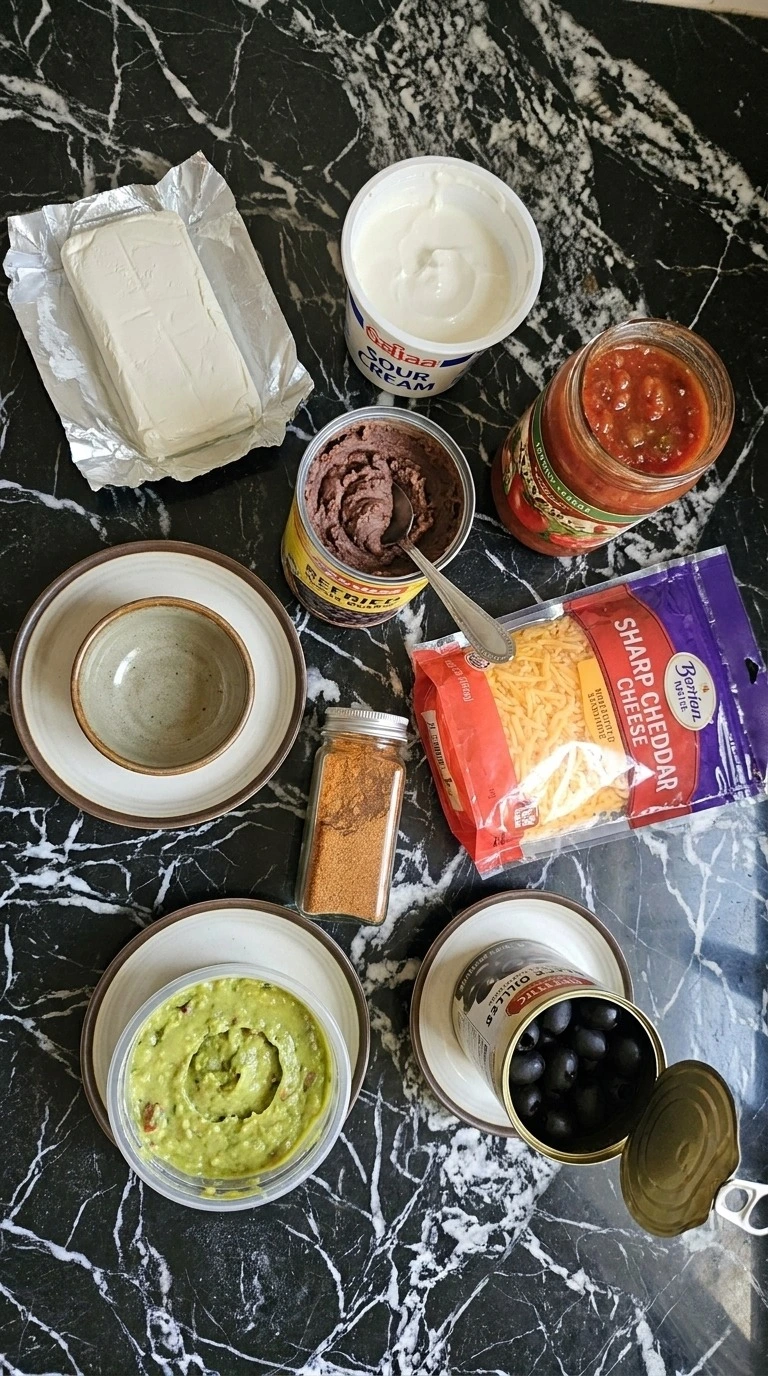 Halloween Food for Party Appetizers Dip ingredients with black beans, cheddar, salsa, guacamole and sour cream Recipe focus: fall dips and appetizers.