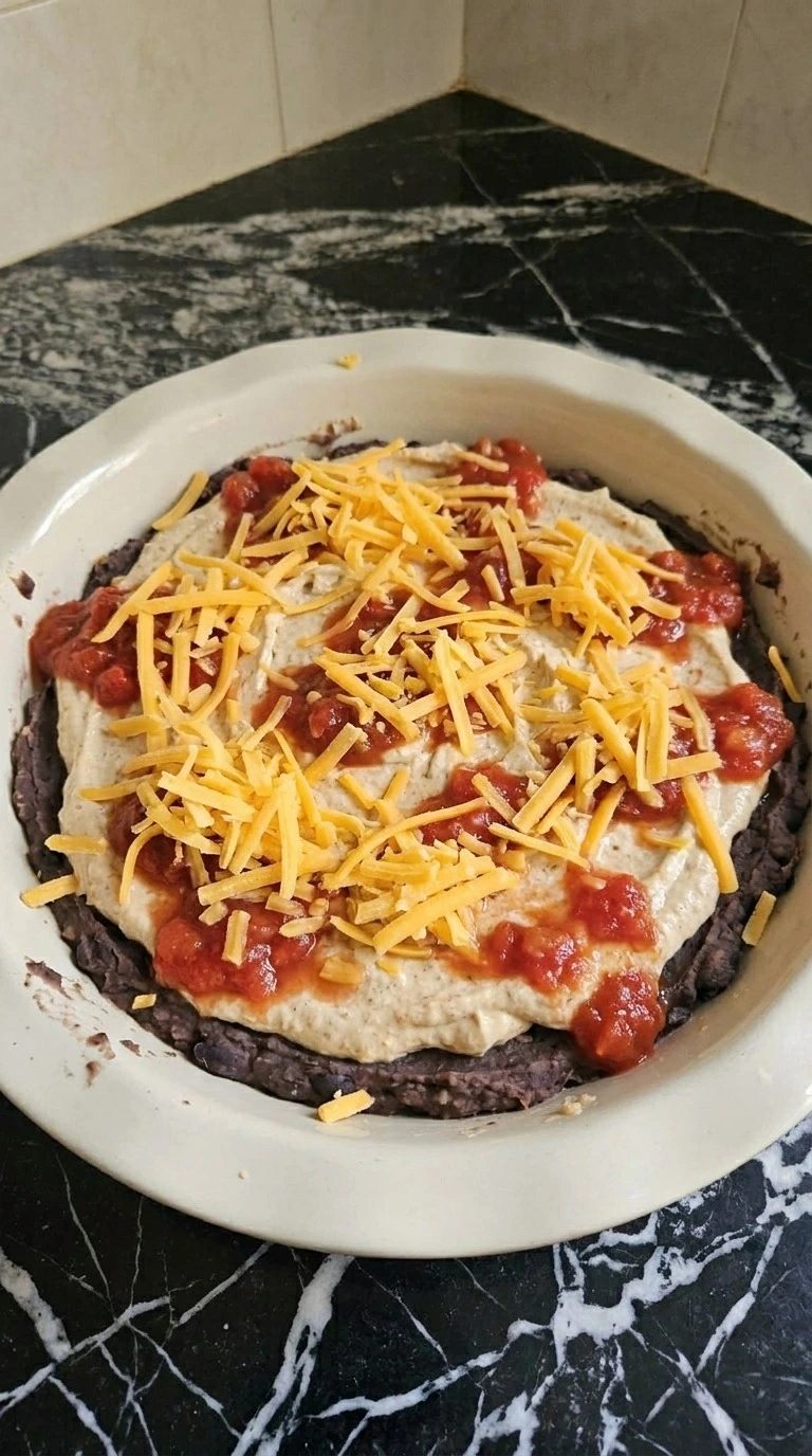 Halloween Food for Party Appetizers Dip layered with black beans, salsa, cream mixture and sharp cheddar Recipe focus: savory halloween snacks.