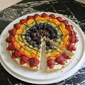 Halloween Fruit Pizza with golden cookie crust, cream cheese frosting, fresh fruit and a chocolate spiderweb Recipe focus: fruit pizza halloween.