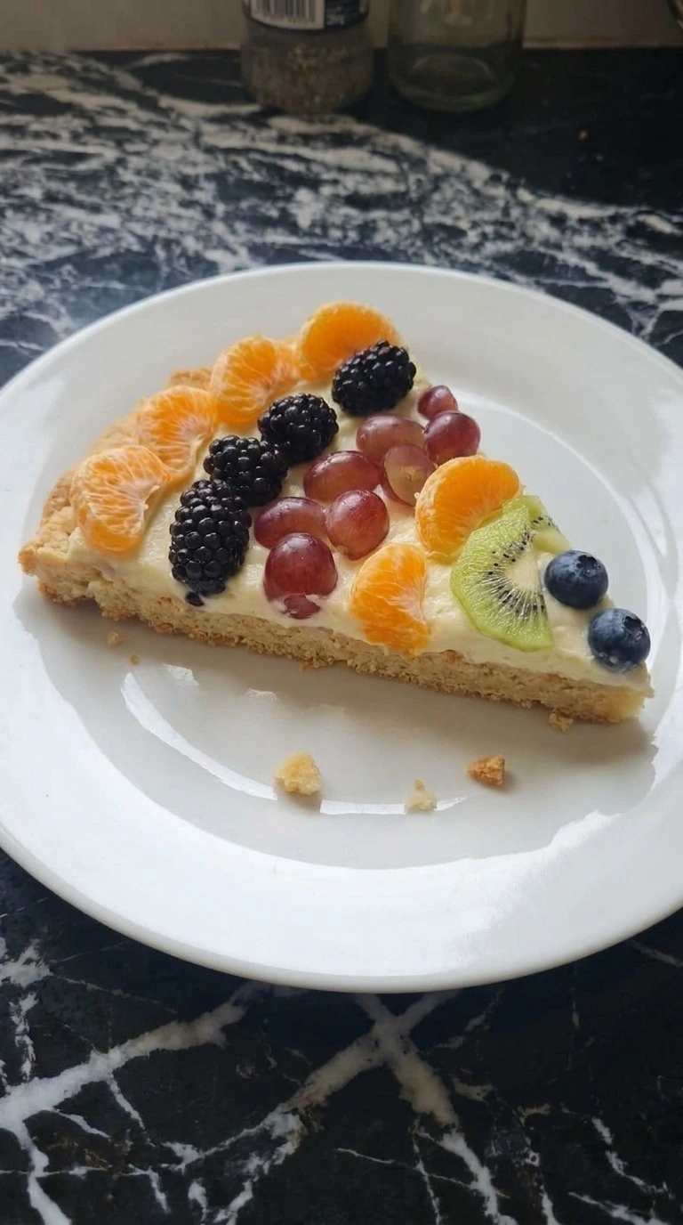 Halloween Fruit Pizza Sugar Cookie wedge showing soft cookie crust, cream cheese layer and fresh fruit