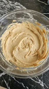 Halloween Peanut Butter Spider Cookies step 1 with pale tan creamed peanut butter cookie base in a mixing bowl