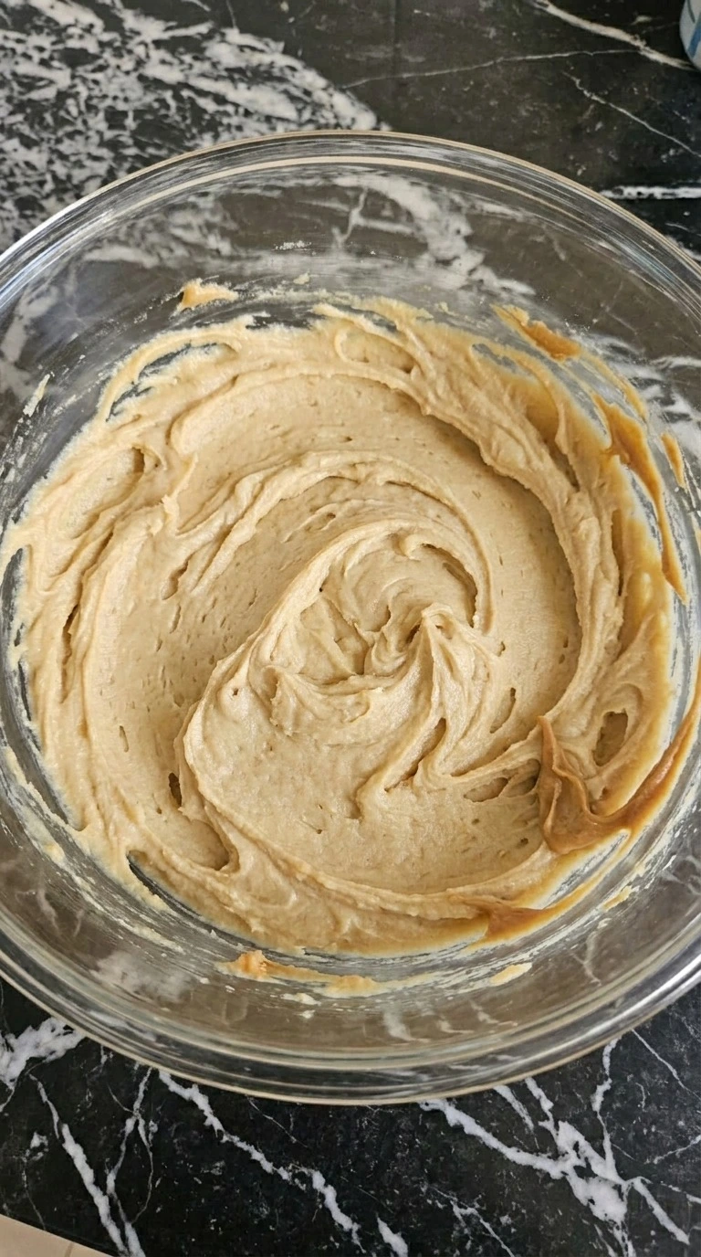 Halloween Peanut Butter Spider Cookies step 1 with pale tan creamed peanut butter cookie base in a mixing bowl