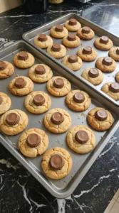 Halloween Peanut Butter Spider Cookies step 4 with mini chocolate peanut butter cups pressed into warm cookie centers