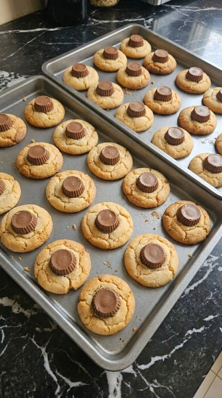 Halloween Peanut Butter Spider Cookies step 4 with mini chocolate peanut butter cups pressed into warm cookie centers