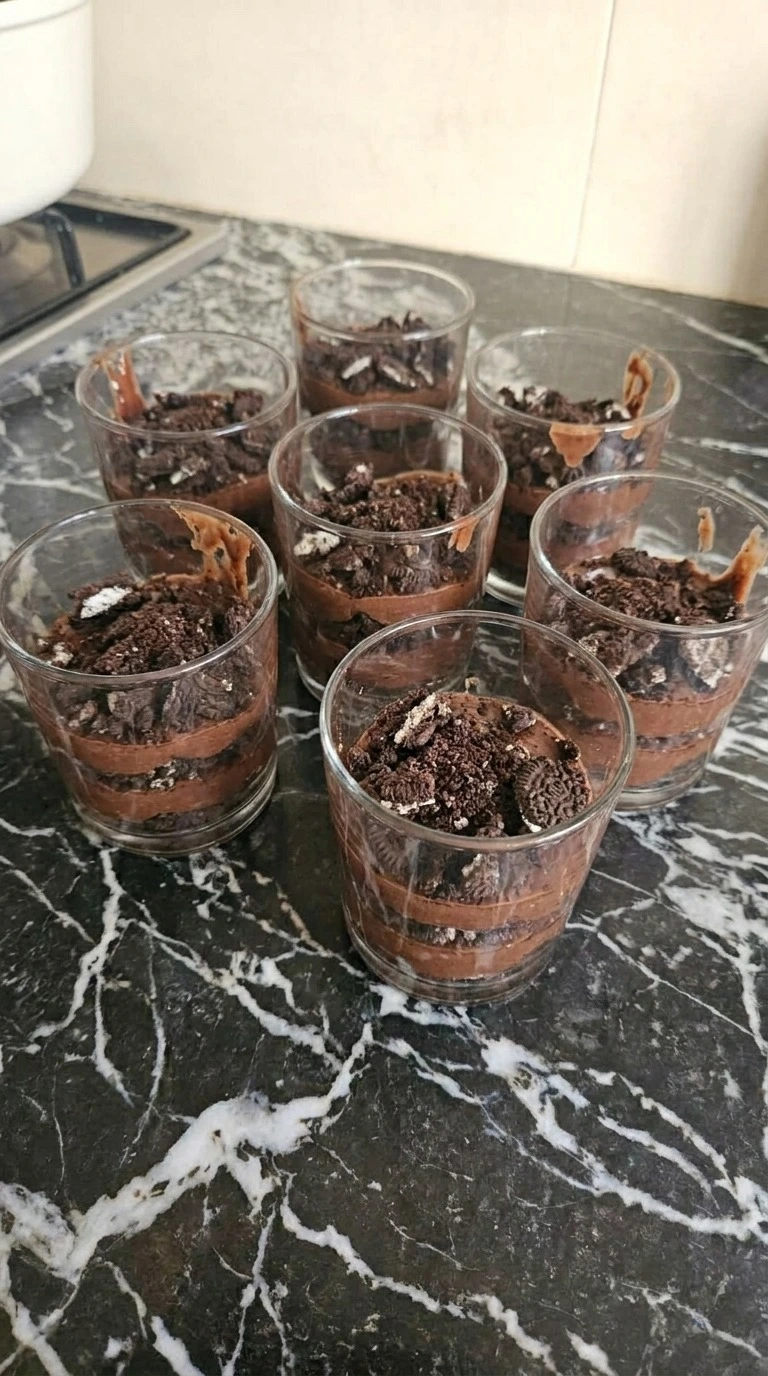 Halloween Pudding Dirt Cups layered with chocolate pudding and cookie crumbs Recipe focus: halloween Recipe focus: how to make halloween pudding dirt cups.