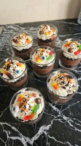 Halloween Pudding Dirt Cups topped with whipped cream and candy Recipe focus: how to make halloween pudding dirt Recipe focus: halloween dirt pudding cups.