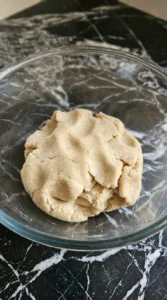 Halloween Pumpkin Cookies Royal Icing dough mixed smooth with visible cinnamon specks in a large bowl