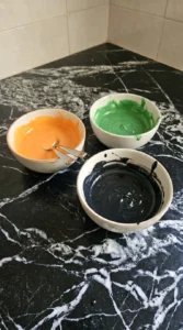Halloween Pumpkin Cookies Royal Icing orange green and black icing mixed to two decorating consistencies
