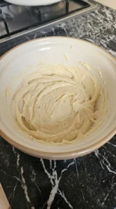 Halloween Pumpkin Designs step showing pale creamed butter and sugar mixture before the flour is added