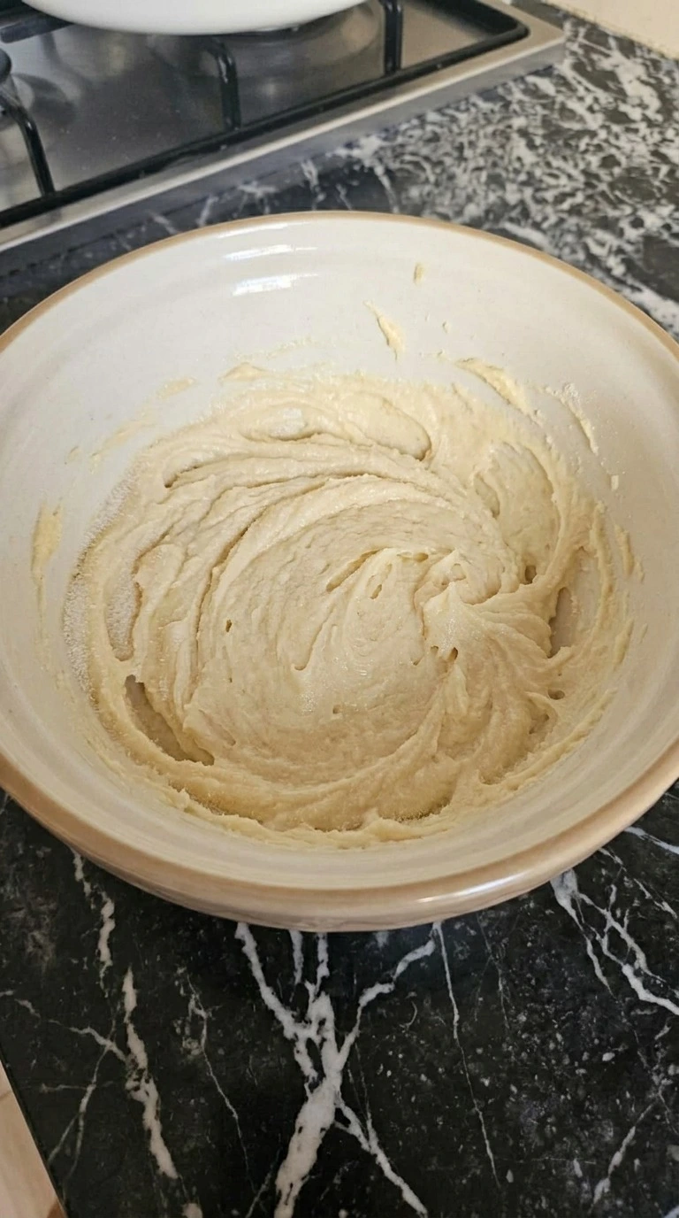 Halloween Pumpkin Designs step showing pale creamed butter and sugar mixture before the flour is added