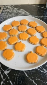 Halloween Pumpkin Painting cookies covered with smooth orange icing before black and green details are added Recipe focus: halloween pumpkin painting ideas.