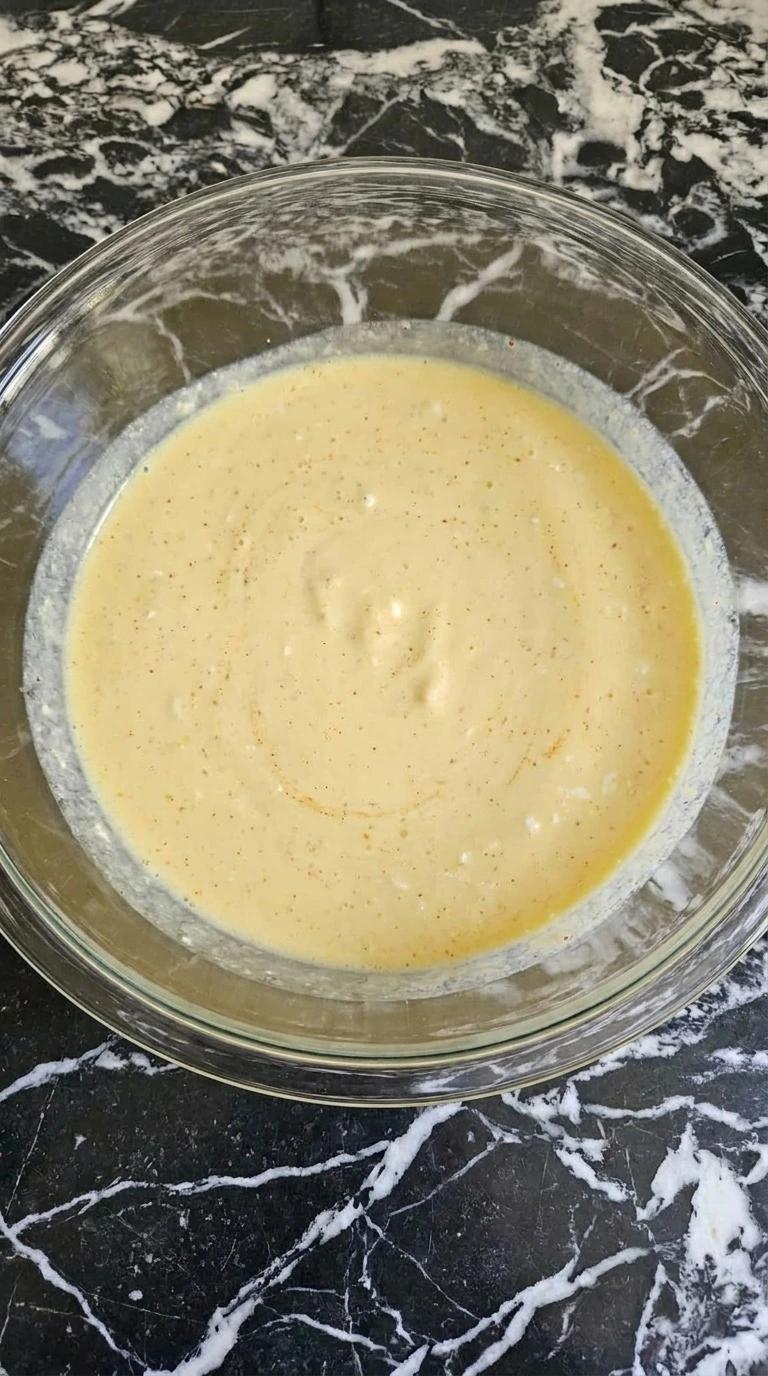 Hashbrown Breakfast Casserole step showing smooth pale egg custard with paprika specks Recipe focus: hash brown breakfast casserole.