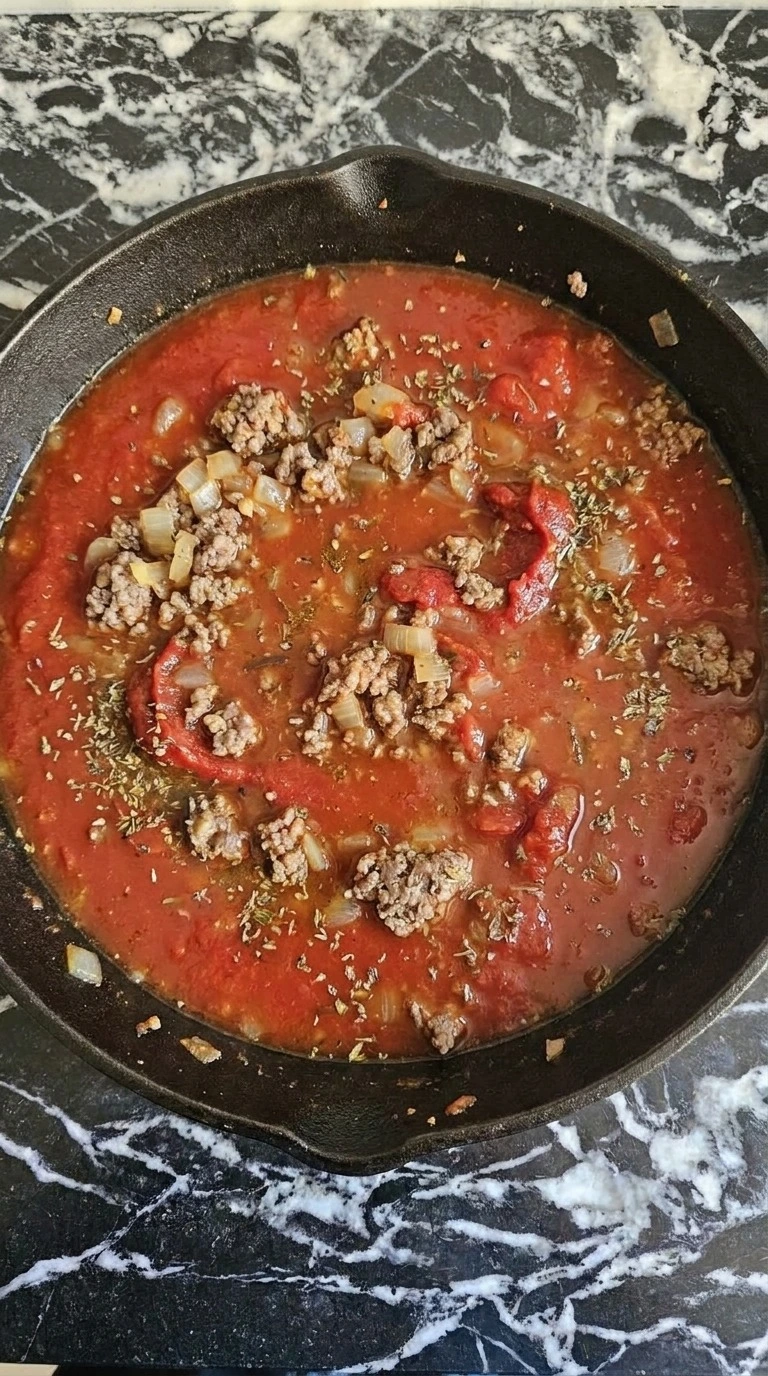 One Pot Lasagna Soup tomato broth simmering with beef and herbs in the pot Recipe focus: lasagna soup recipe.