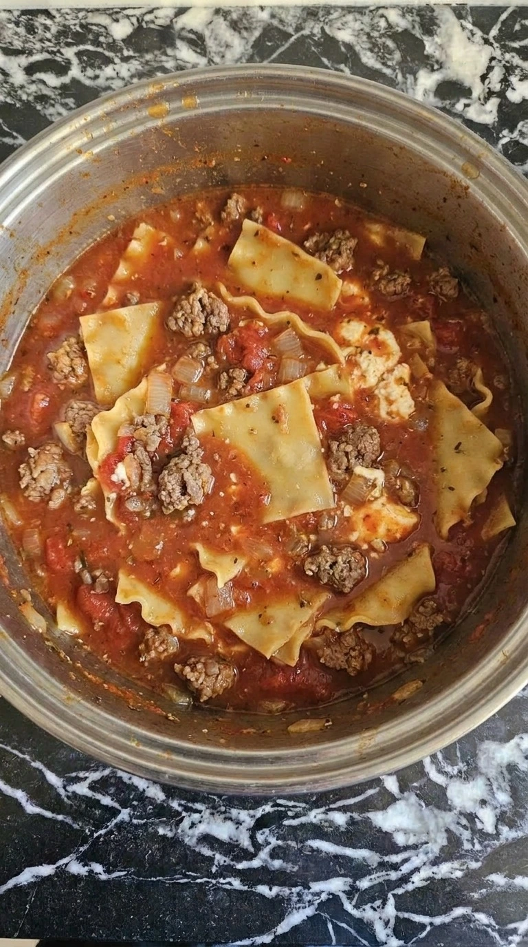 One Pot Lasagna Soup broken noodles softening inside thick tomato broth Recipe focus: easy lasagna soup.