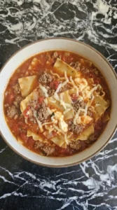 One Pot Lasagna Soup final bowl with melted cheese and tomato noodles Recipe focus: creamy lasagna soup.