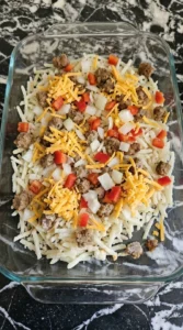 Overnight Breakfast Casserole layered with hashbrowns sausage and cheddar Recipe focus: biscuits and gravy breakfast casserole.