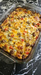 Overnight Breakfast Casserole baking with golden hashbrowns and melted cheese Recipe focus: breakfast casserole with hashbrowns.