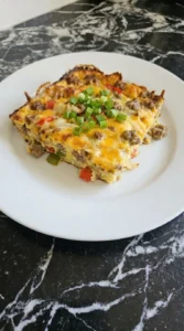 Overnight Breakfast Casserole slice served with golden edges and herbs Recipe focus: easy breakfast casserole.