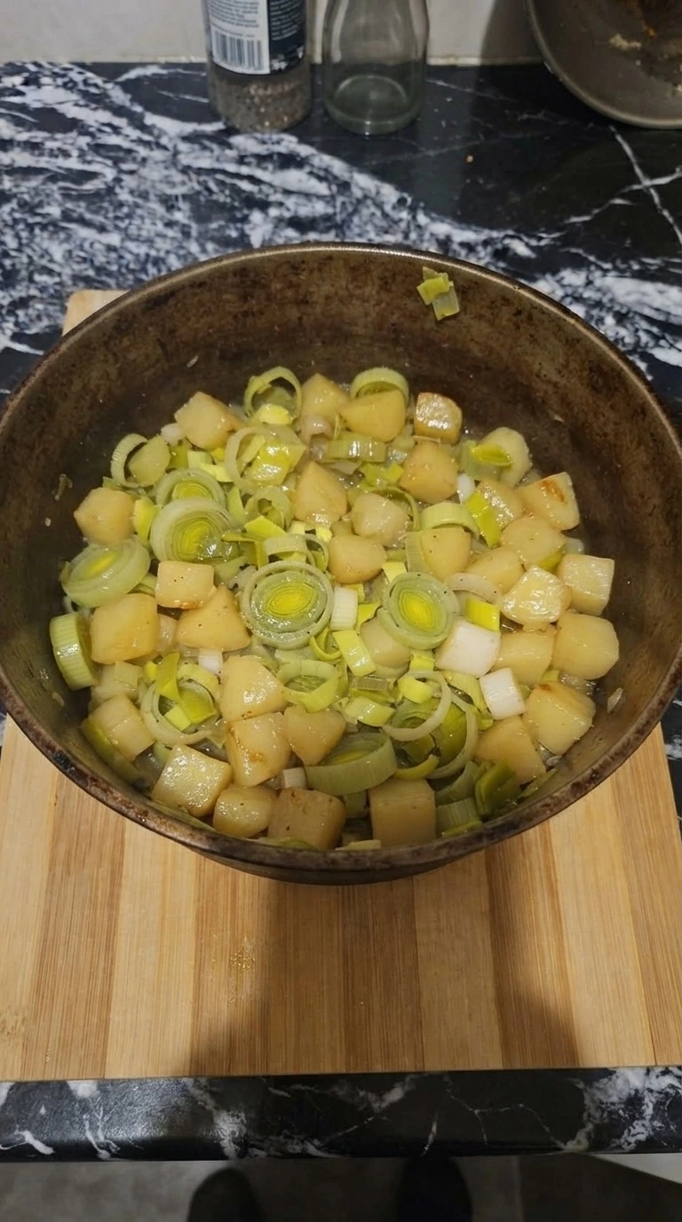 Potato Leek Soup step 2 with softened leeks and potatoes in pot Recipe focus: potato leek soup recipe.