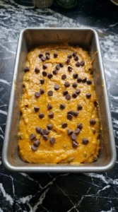 Pumpkin Bread with Chocolate Chips batter folded with semisweet chocolate chips in a loaf pan Recipe focus: fall bread recipes.